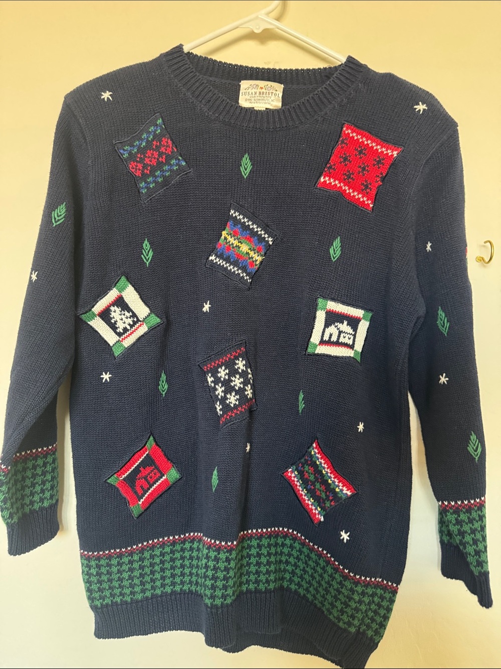Susan Bristol Navy Crewneck Sweater with Red and Green Patch Motifs